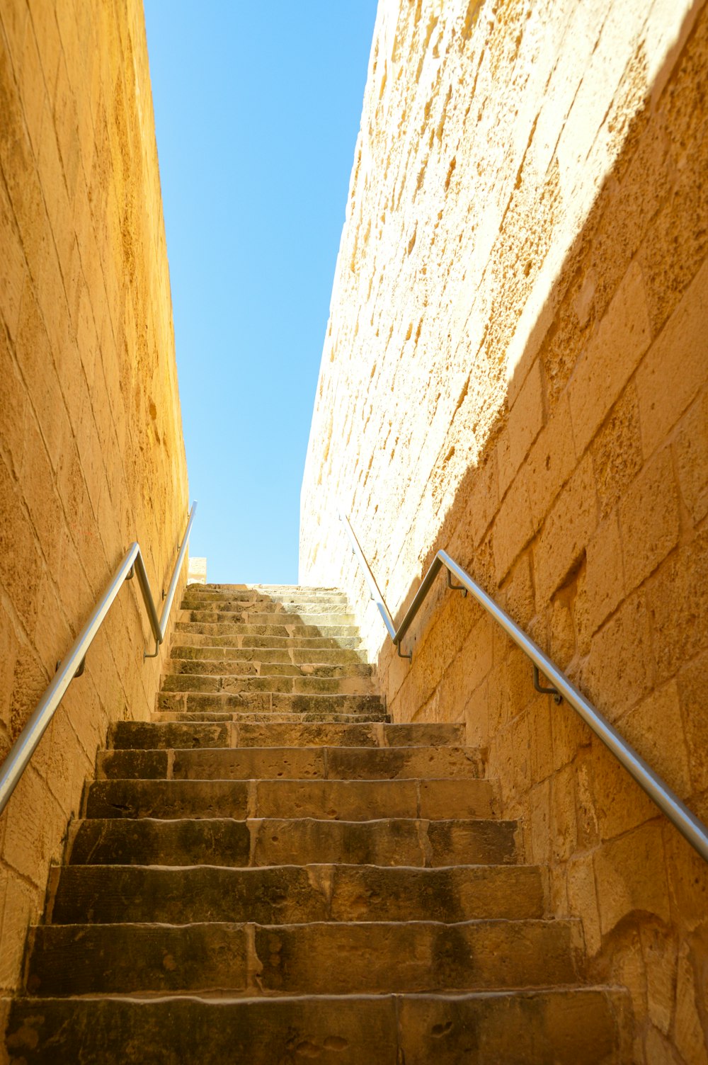 gray concrete stairs under blue sky during daytime