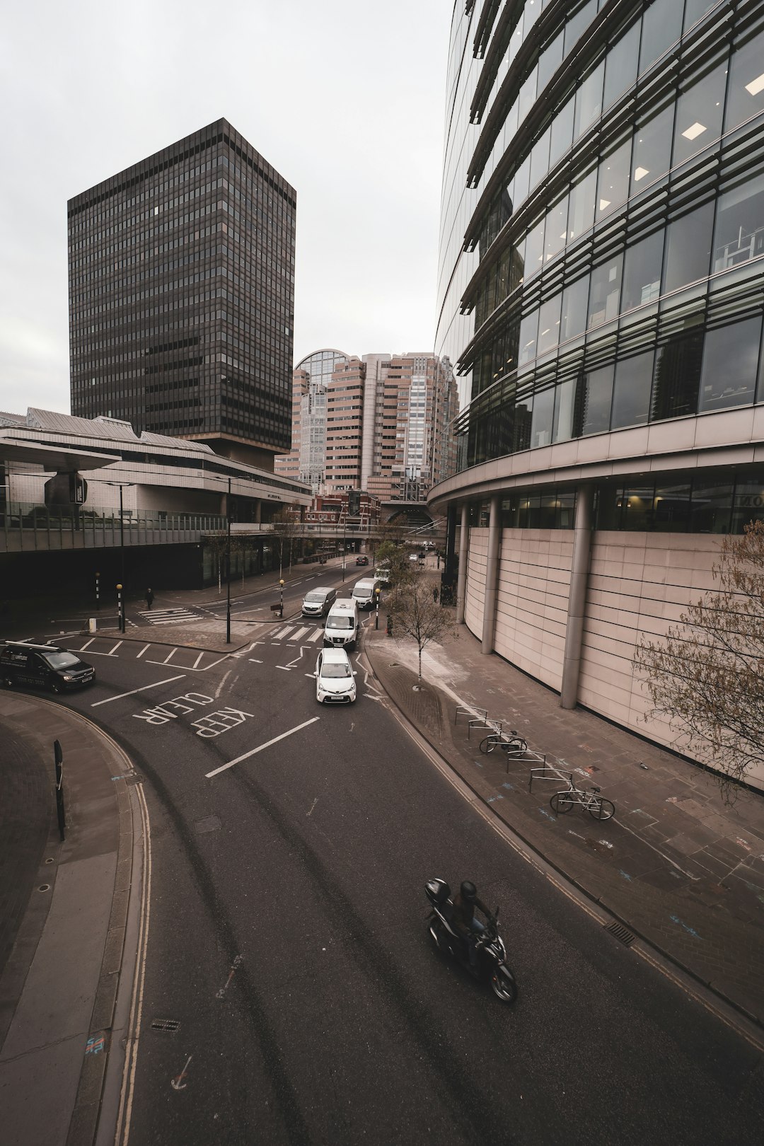 cars on road near high rise buildings during daytime