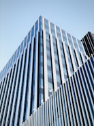 A modern building facade featuring sleek glass and aluminium panels.