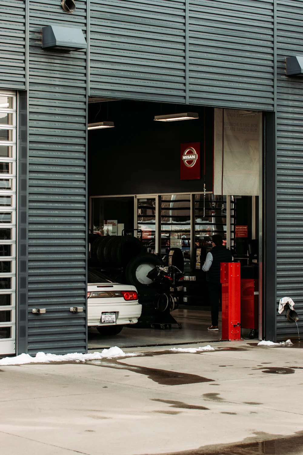 Open auto repair shop bay with a vehicle inside on the service floor