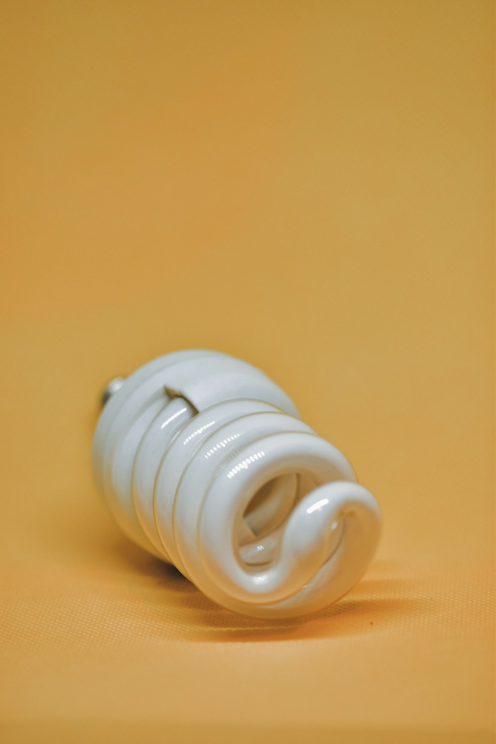 white plastic round ornament on brown wooden table