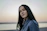 woman in blue shirt standing near body of water during daytime