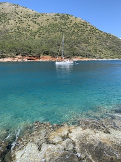 white boat on blue sea during daytime