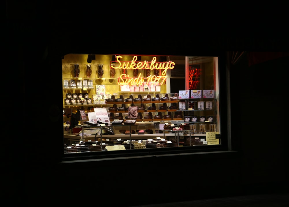 yellow lighted candles on black rack