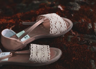 white and brown floral flat sandals