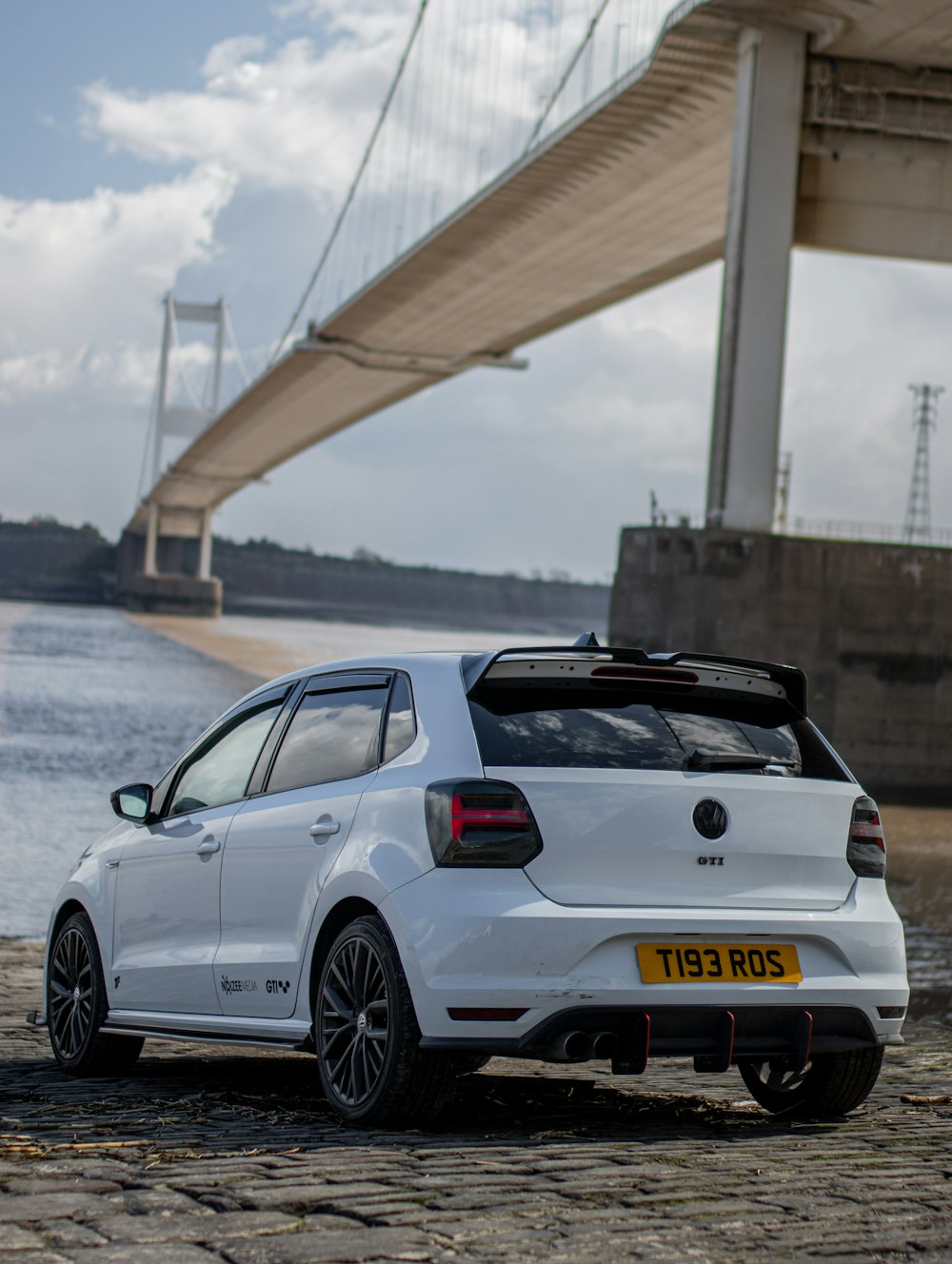 white porsche 911 parked on bridge during daytime