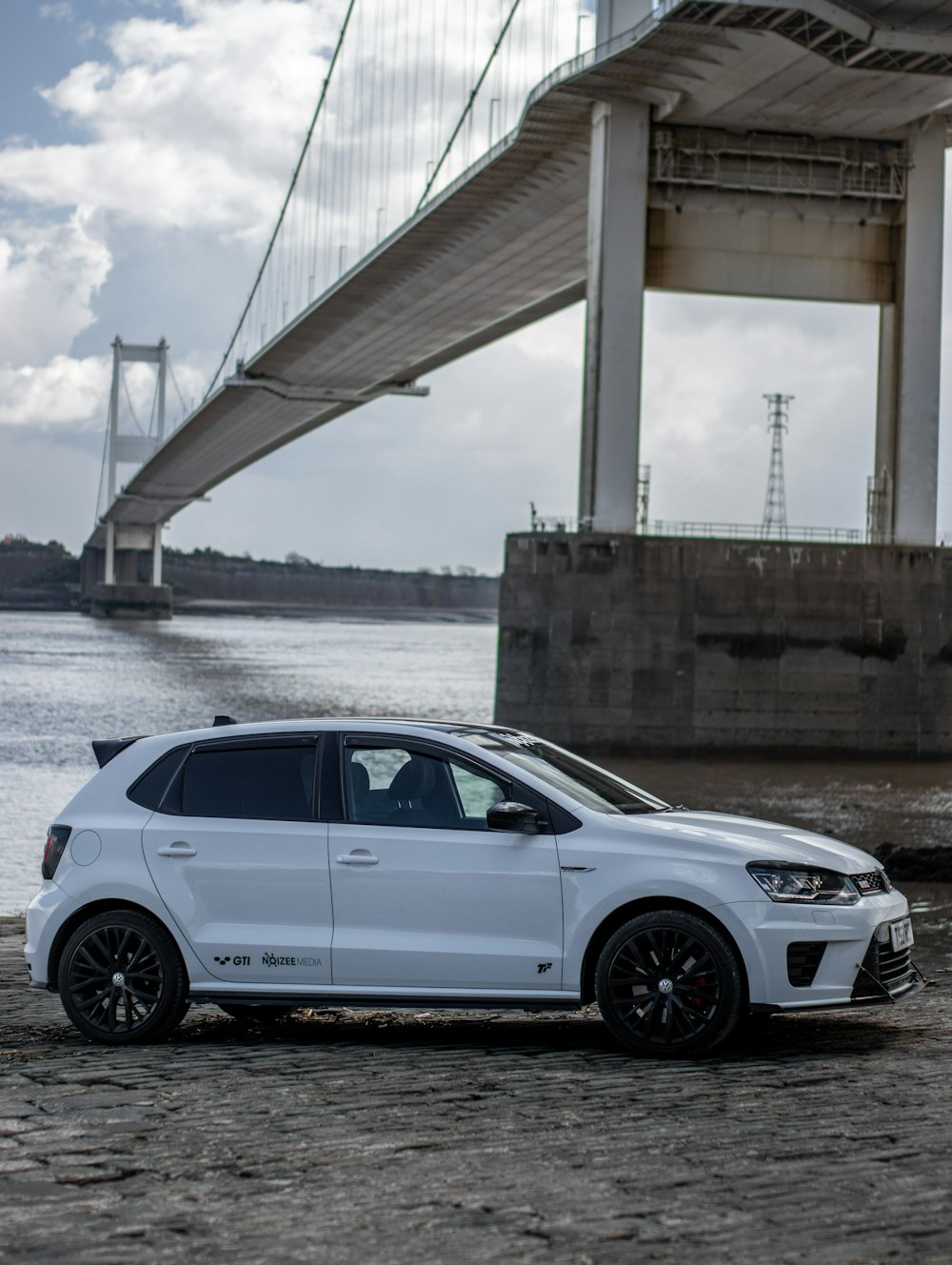 white sedan on gray concrete bridge during daytime