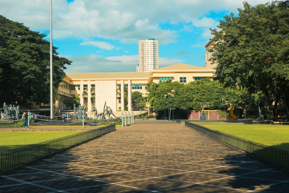 white concrete building near green trees under blue sky during daytime