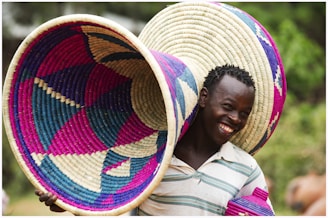 A smiling person receiving a breakfast basket as a surprise gift.