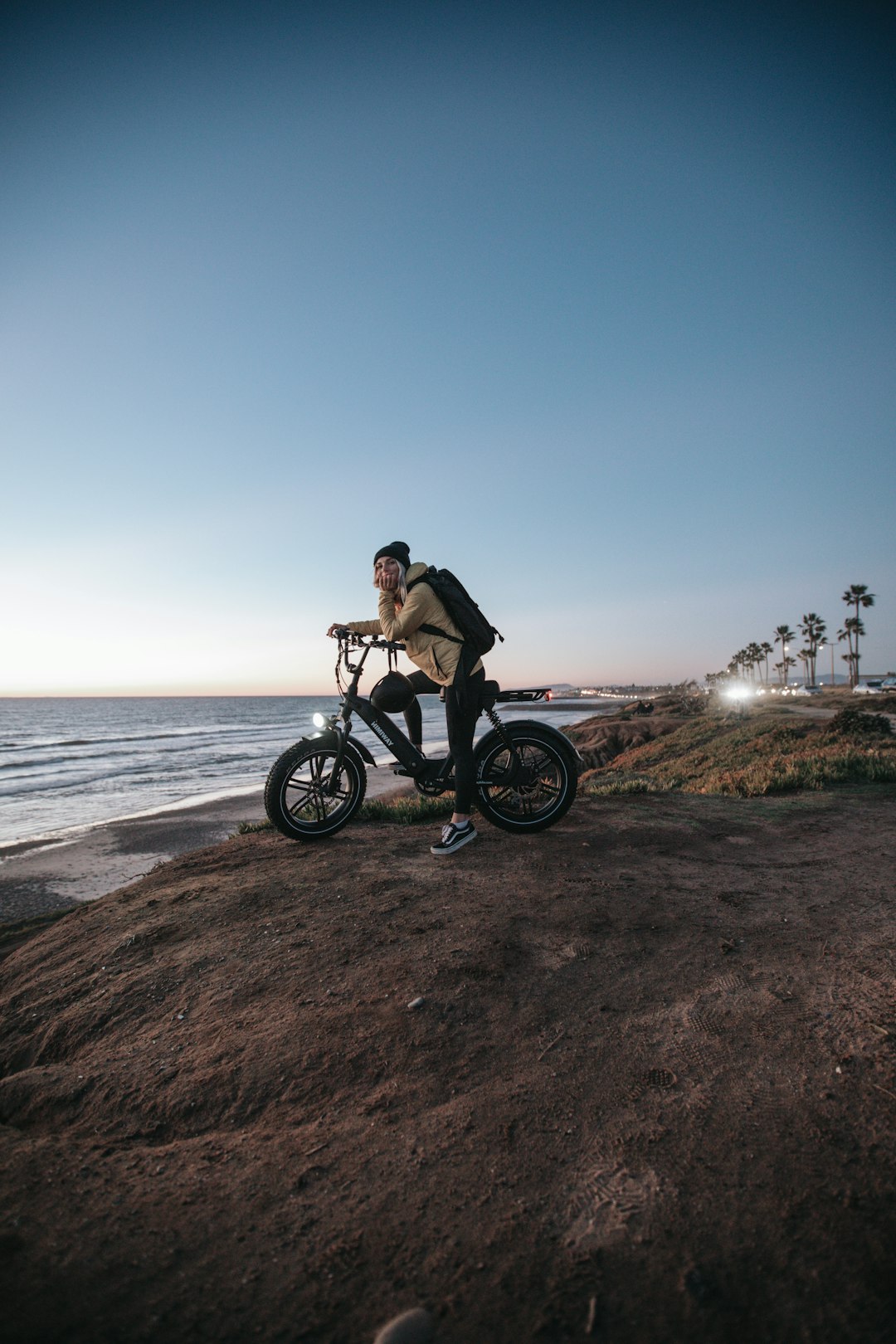 man in black jacket riding on black motorcycle near sea during daytime