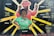 A vibrant mural features two figures with bold expressions, highlighting themes of justice and community empowerment. The foreground figure is wearing a green shirt with pins that read 'Defend Freddie Gray' and 'Save Mumia'. Behind, a figure in a pink suit raises a fist. Radiant yellow beams surround the figures, and words like 'Respect', 'Freedom', 'Peace', and 'Justice' are scattered across the background. The mural includes names and phrases referencing social justice and historical figures.