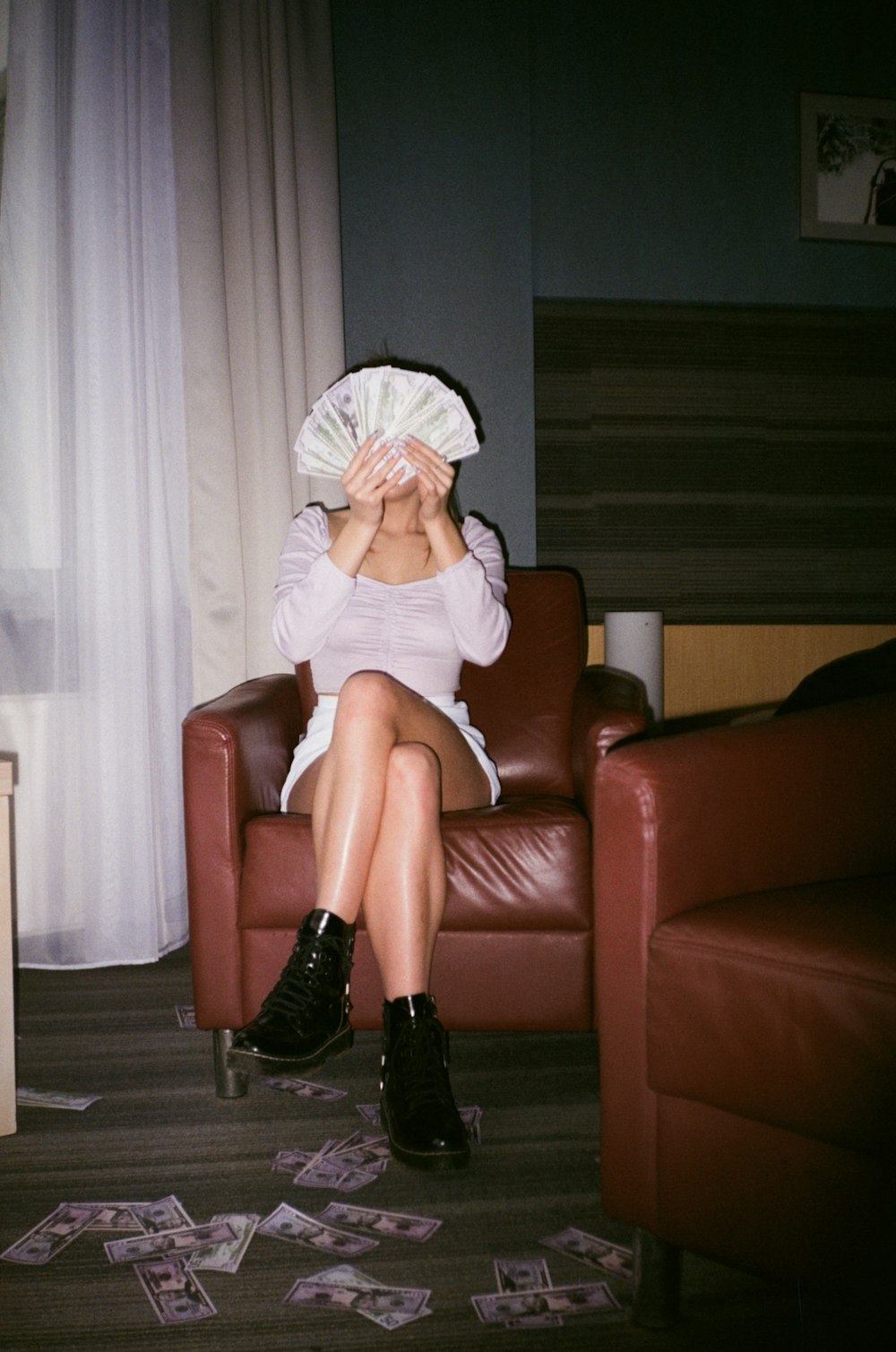 woman in white hijab sitting on brown leather armchair