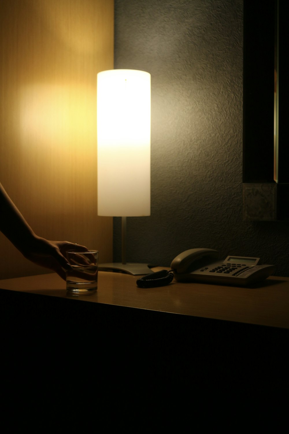 은색과 흰색 테이블 램프를 들고 있는 사람