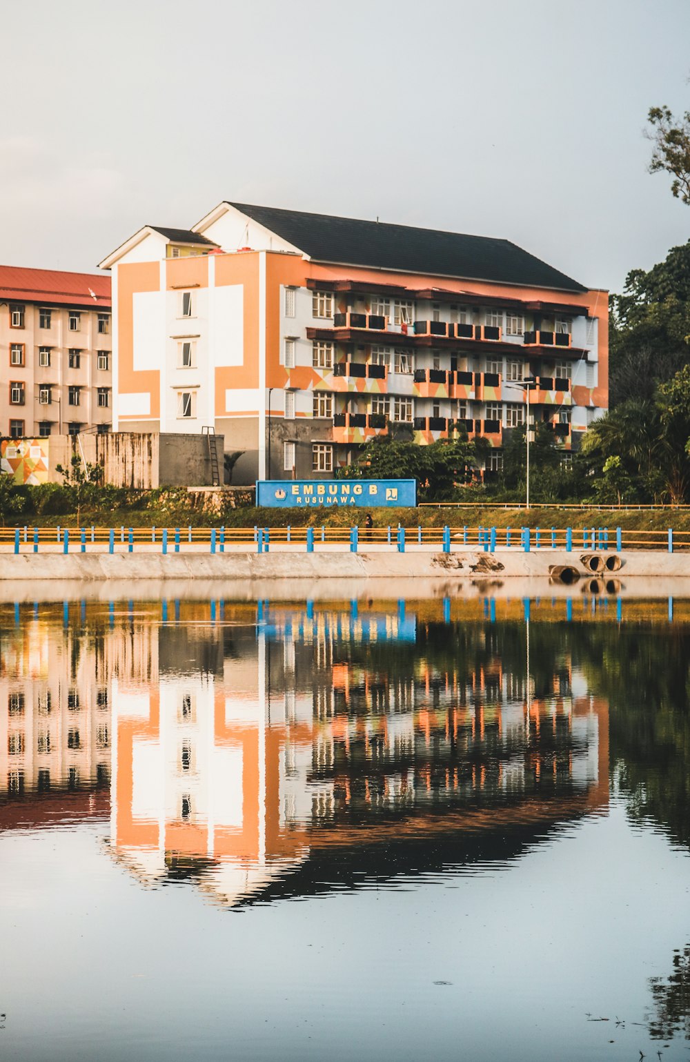 white and brown concrete building near body of water during daytime