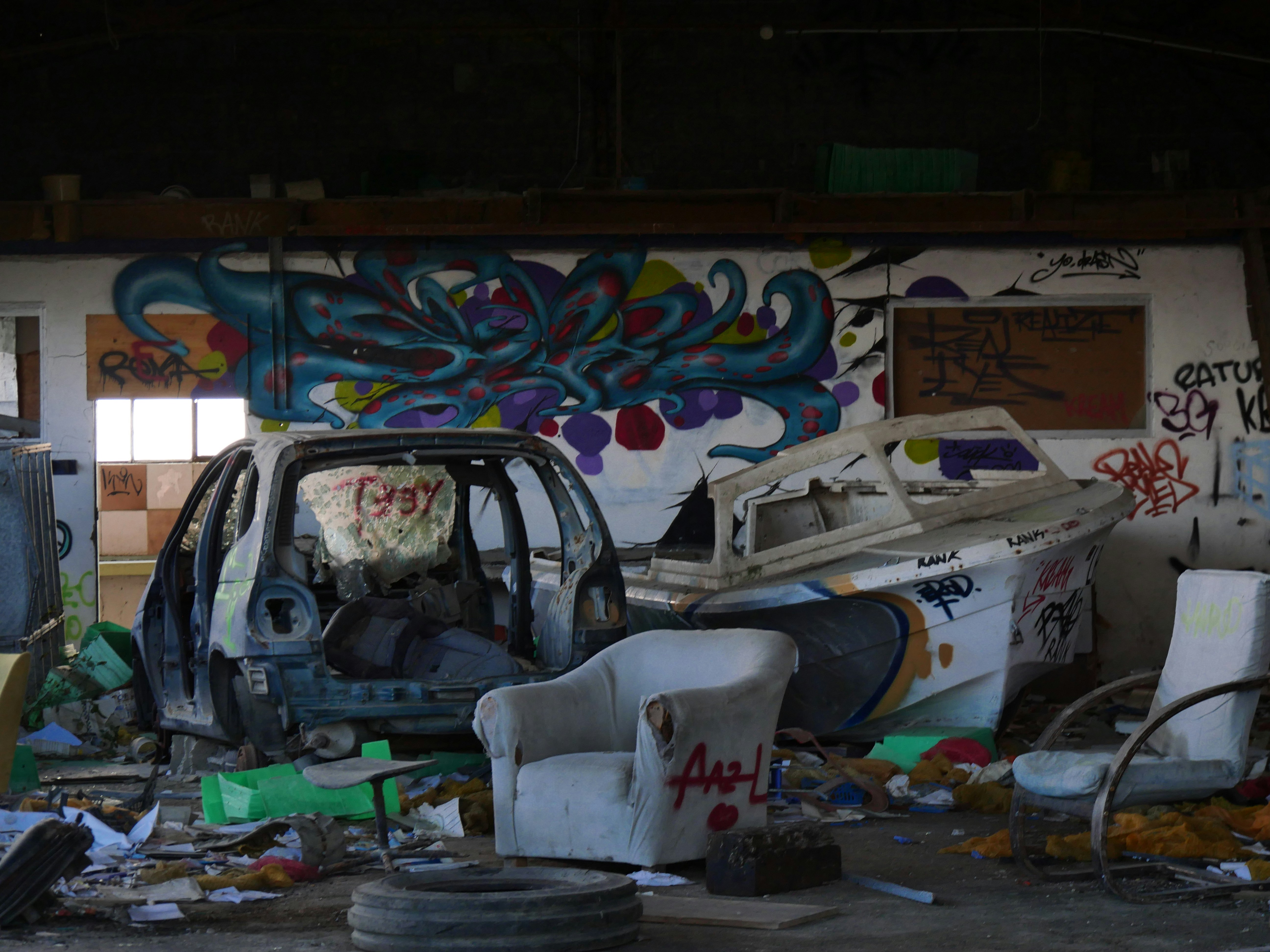 white and blue car on garage