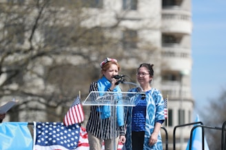woman in blue jacket holding blue shopping cart