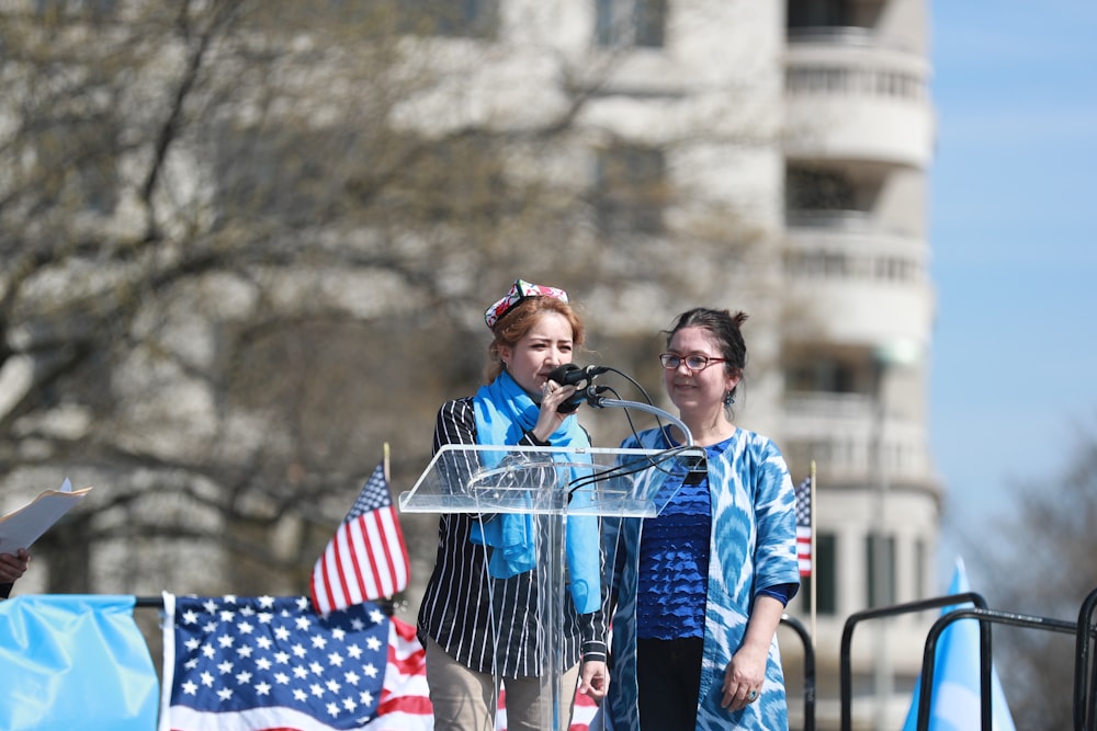 woman in blue jacket holding blue shopping cart