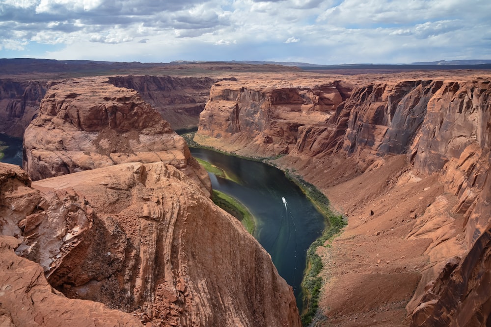 brown rock formation near river during daytime