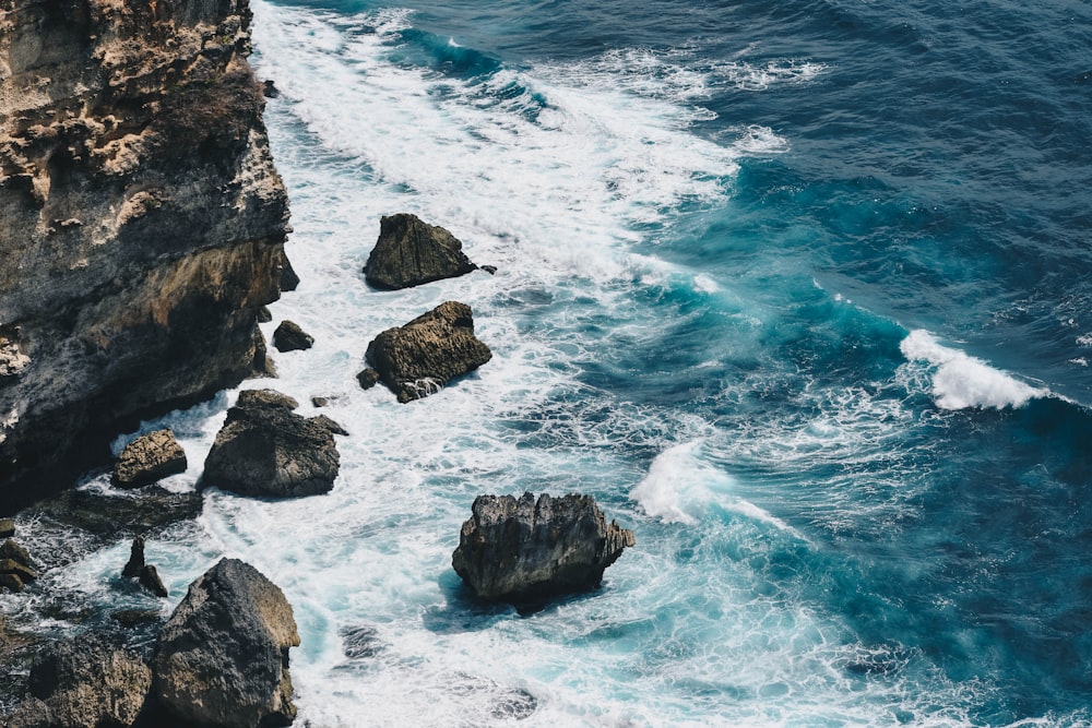 brown rock formation on sea during daytime