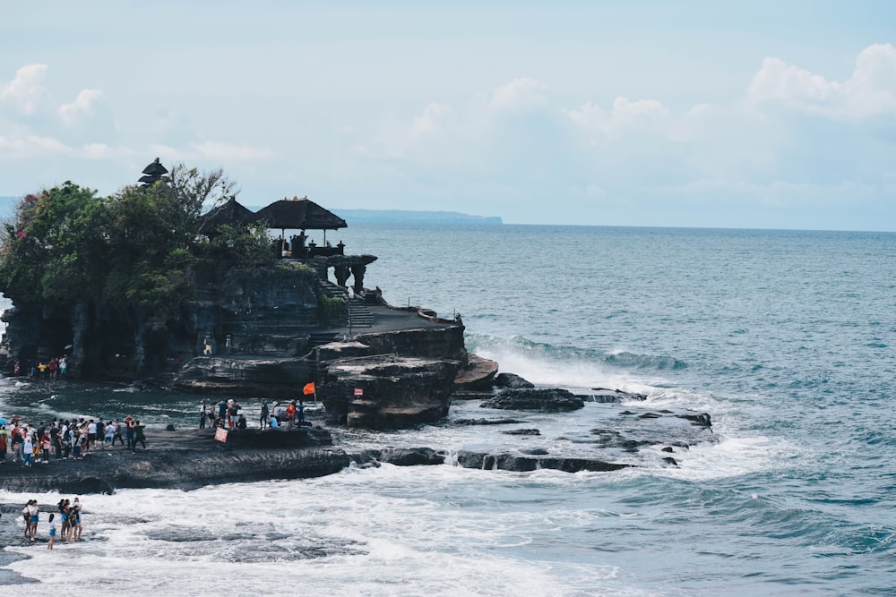 black boat on sea near green trees during daytime