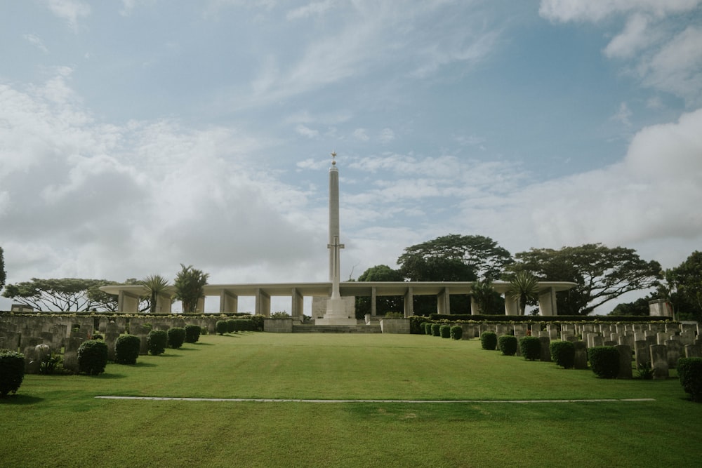 green grass field with white concrete pillar during daytime