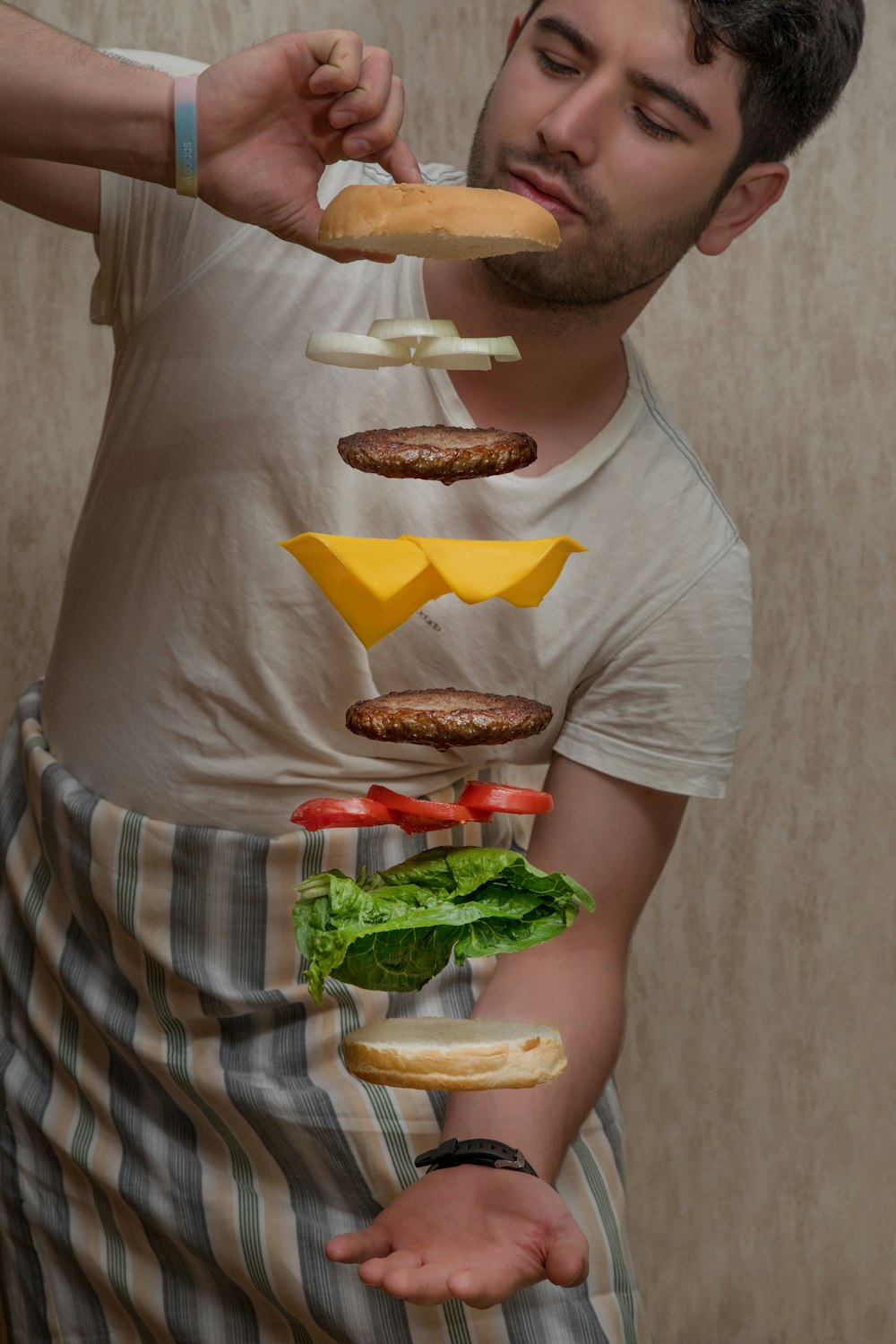 man in white crew neck t-shirt holding burger