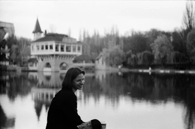 A serene photo of Deacon Minh Nguyen reflecting outdoors with a peaceful backdrop.
