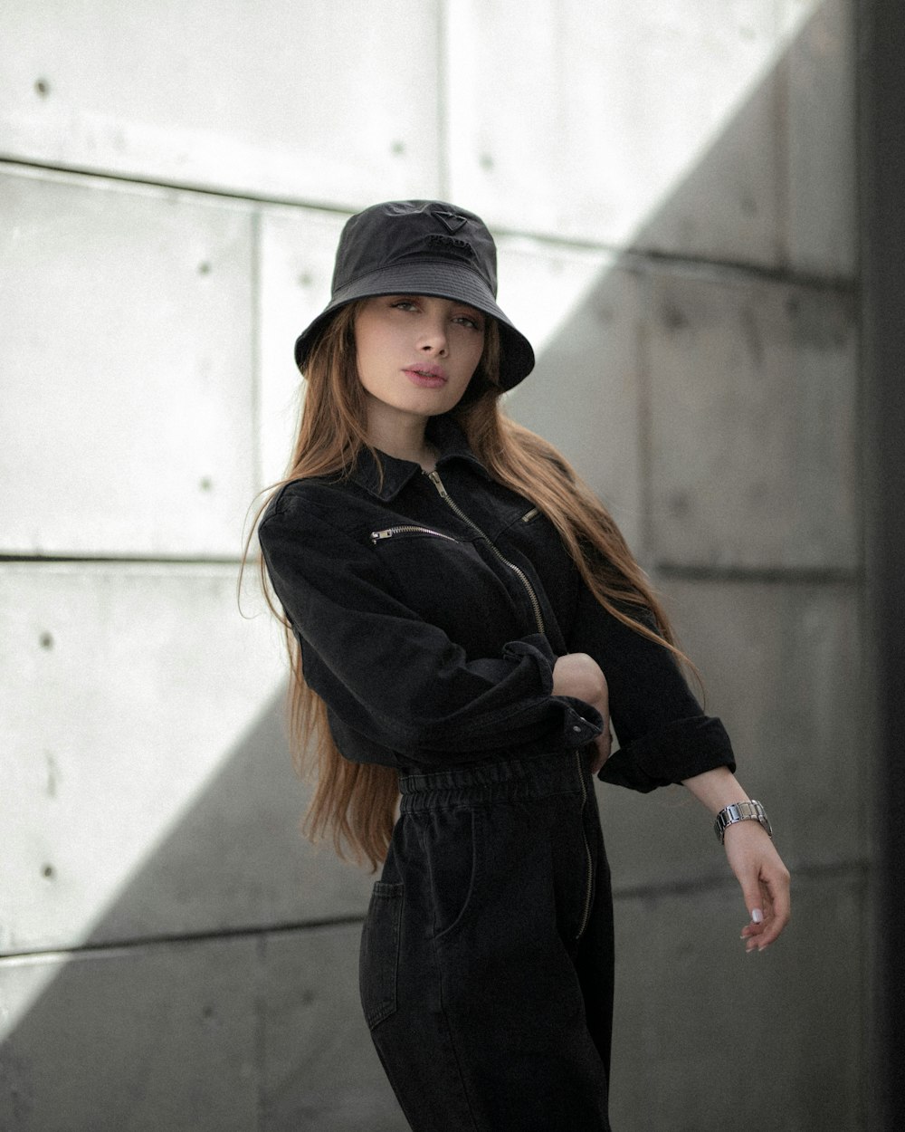 woman in black jacket and black pants wearing black hat