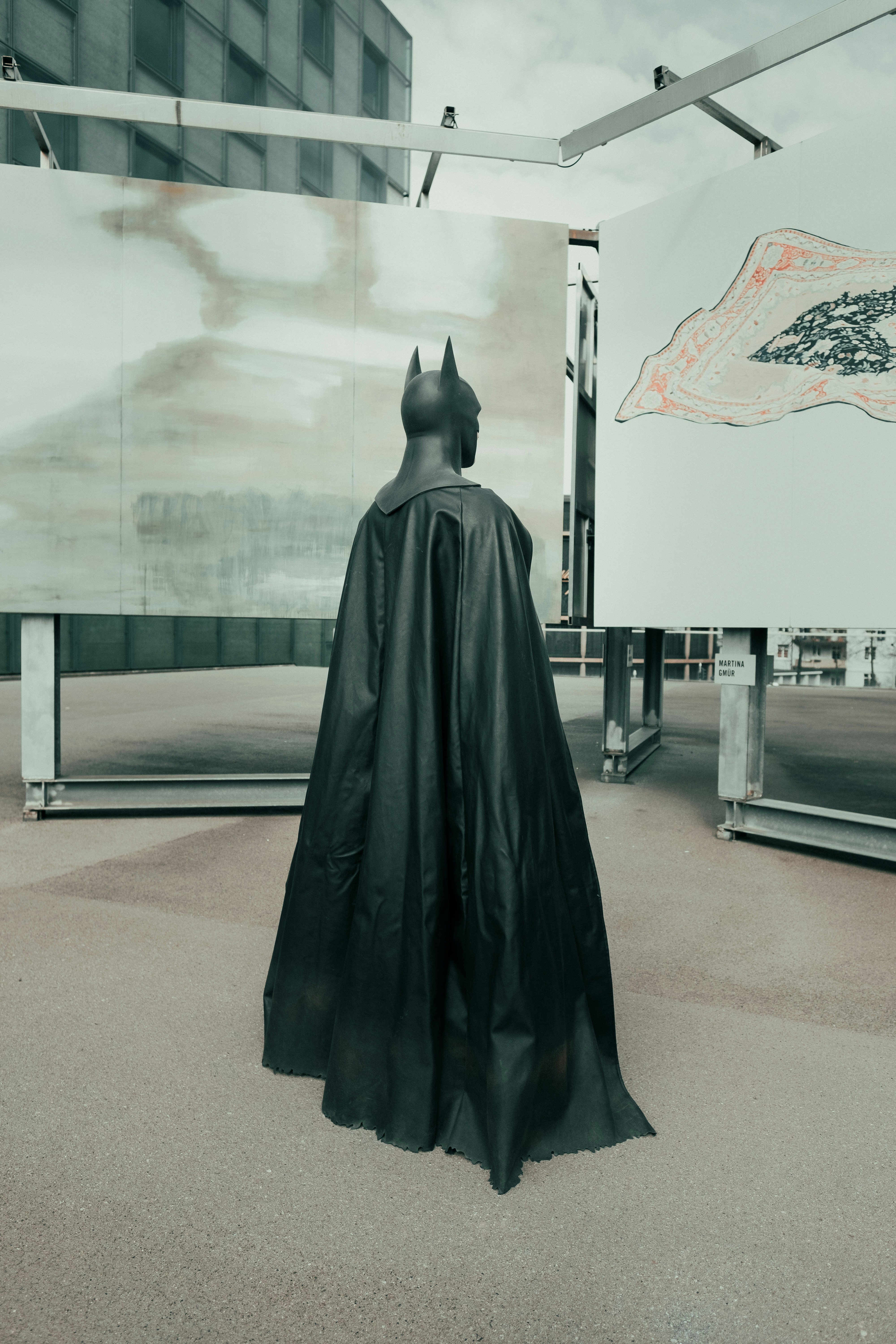 black statue near white building during daytime