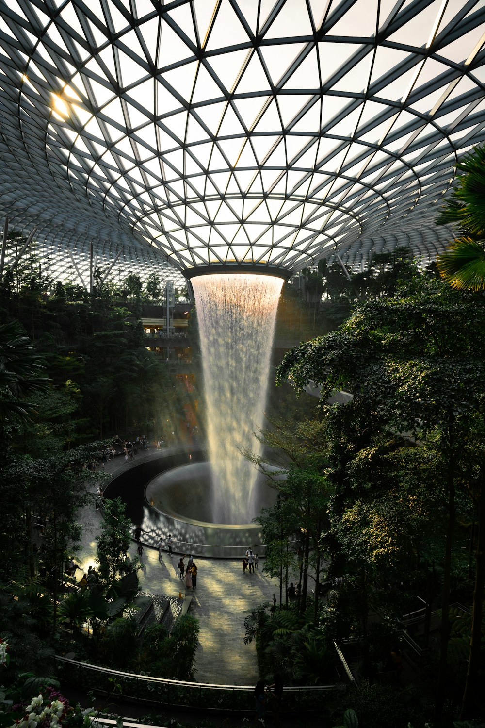 water fountain in the middle of green plants