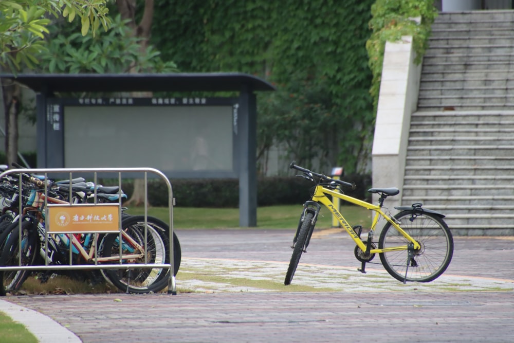 yellow and black bicycle parked on sidewalk during daytime