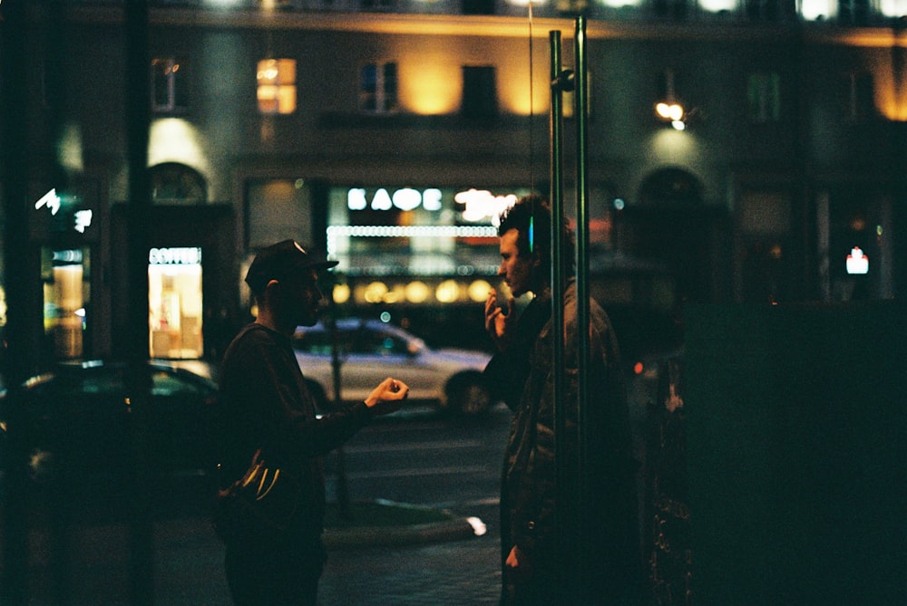 man in black jacket standing beside woman in black coat