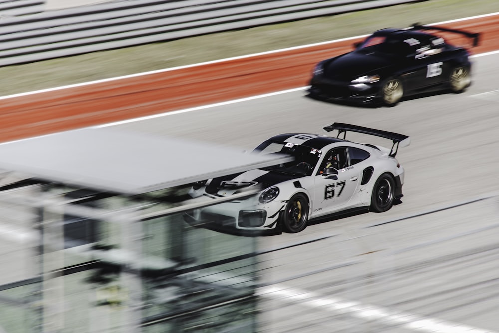 white and black racing car on road
