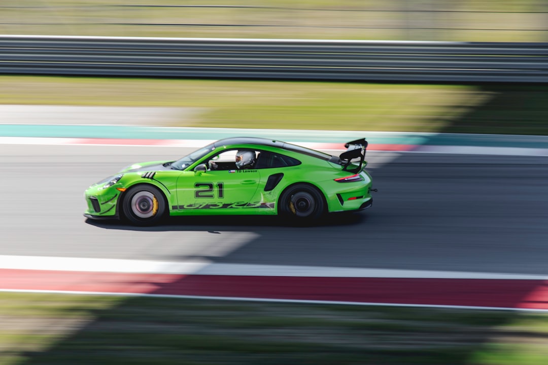 green and black porsche 911 on road