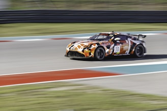 A dynamic image of a virtual racing car speeding on a digital track.