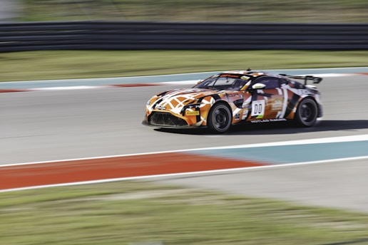 A dynamic image of a virtual racing car speeding on a digital track.