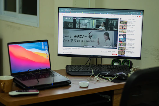 A vibrant workspace showing a person happily using a laptop with earntube's website open.