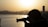 A professional photographer capturing a vibrant cityscape at sunset.