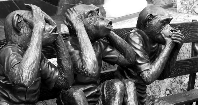 grayscale photo of man and woman statue