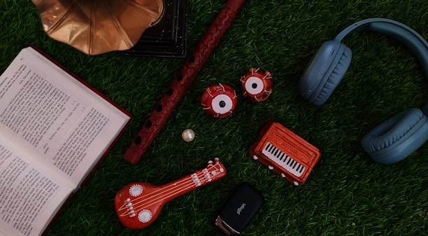 A vibrant display of various Indian musical instruments on a wooden table.