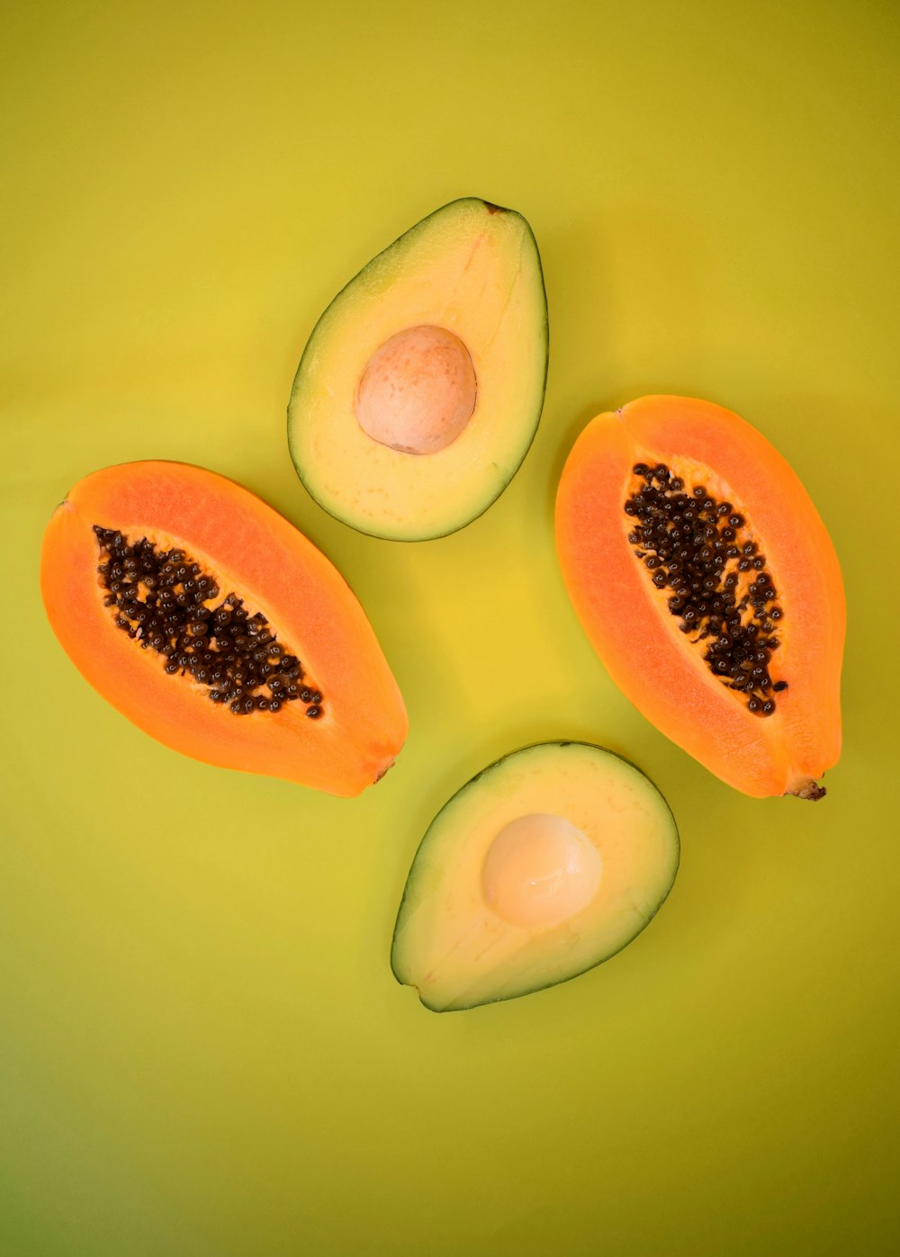 sliced avocado fruit on green surface