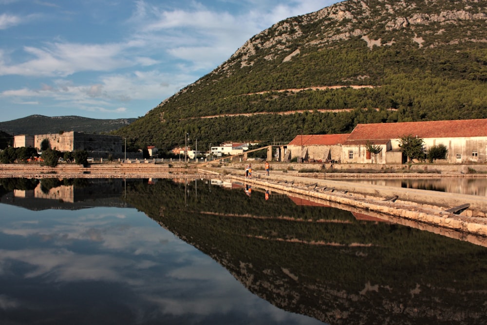 brown and white concrete buildings near body of water during daytime