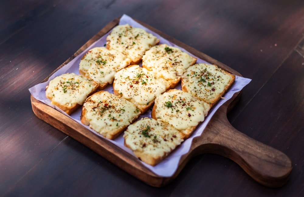 brown and white bread on brown wooden tray