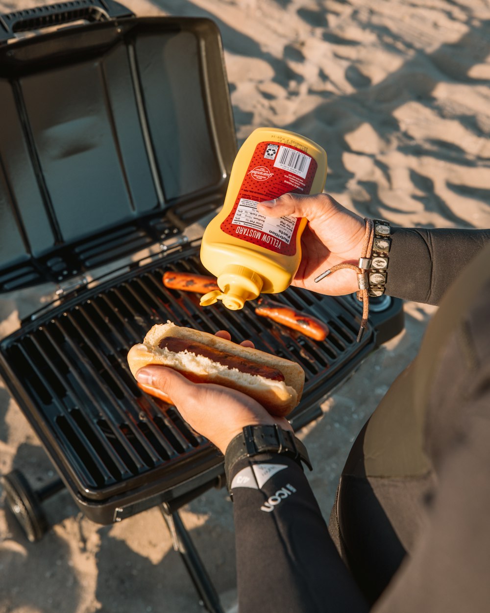 person holding a brown and red burger