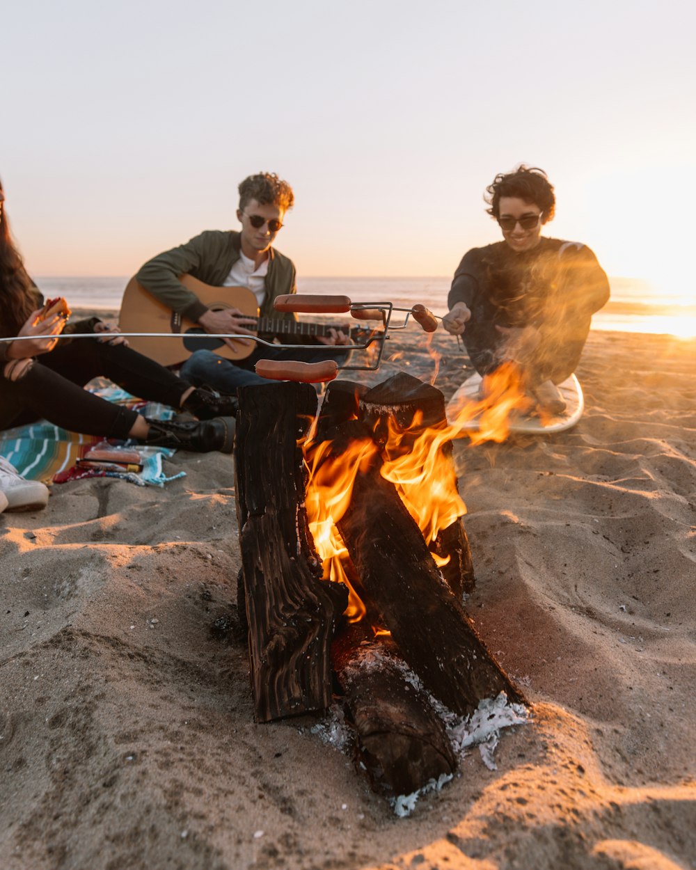 a group of people sitting around a fire pit