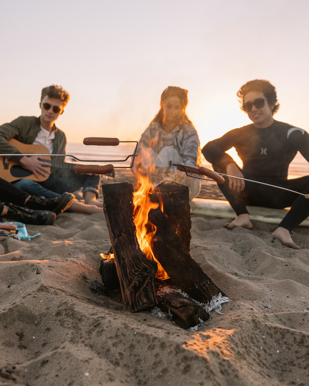 man in black crew neck t-shirt holding stick with fire