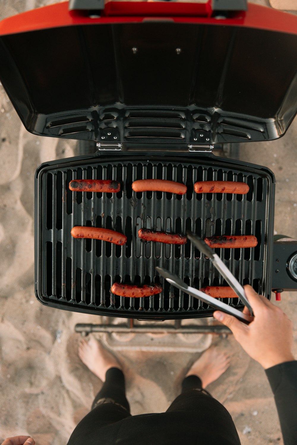 orange and black hair brush on black plastic container