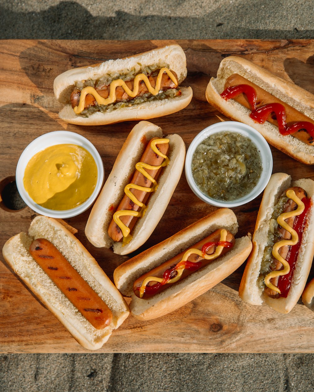 hotdog sandwich with sauce on brown wooden table