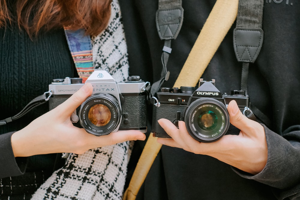 woman holding black and silver camera