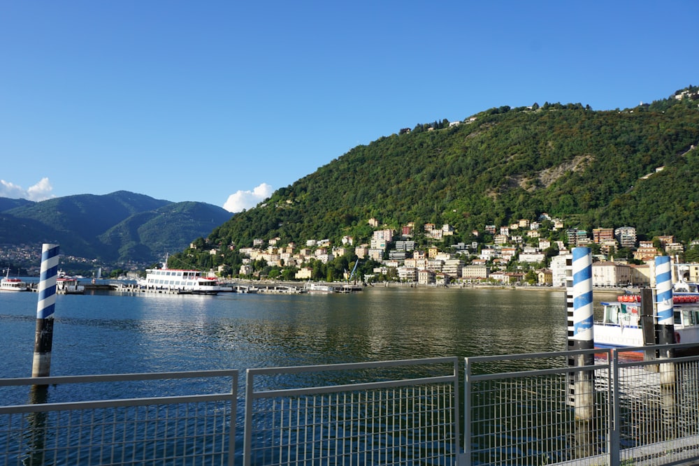 green mountain beside body of water during daytime